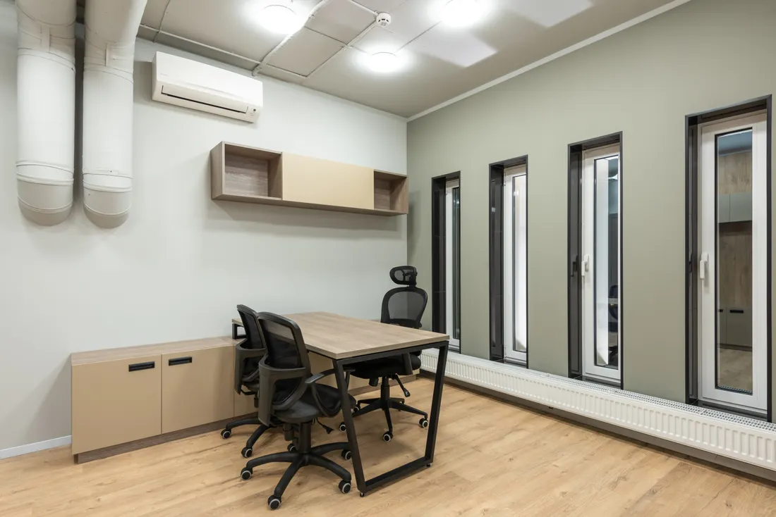 Clean small office with desks and chairs